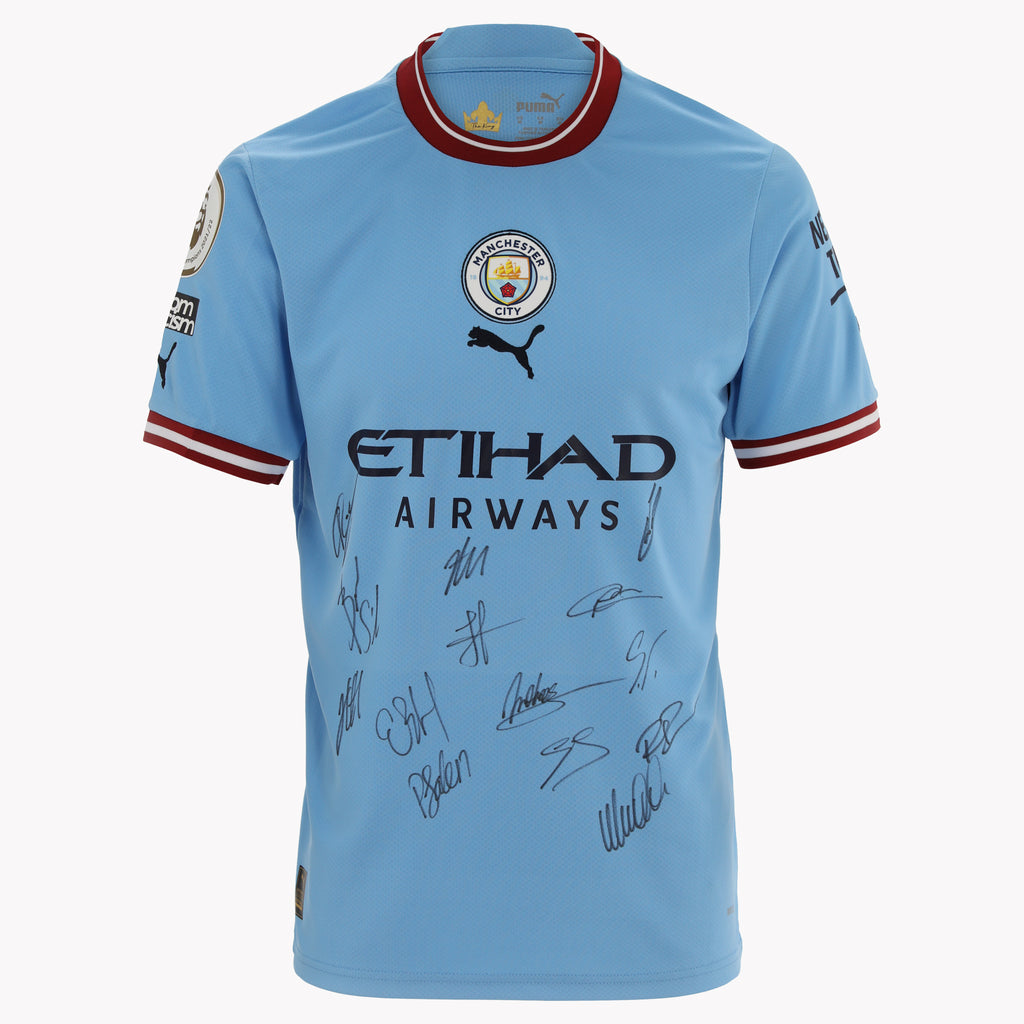 Close-up of Manchester City Premier League 2022-23 Winners Front Signed Shirt, highlighting team.