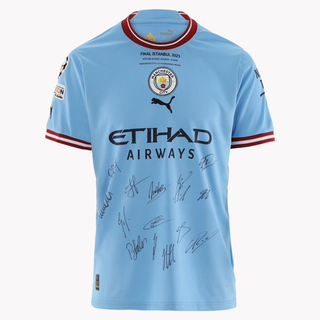 Close-up of Manchester City Front Signed Shirt (Istanbul 2023), highlighting team signatures.